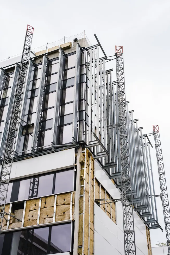 Commercial facade with curtain-wall framing in progress