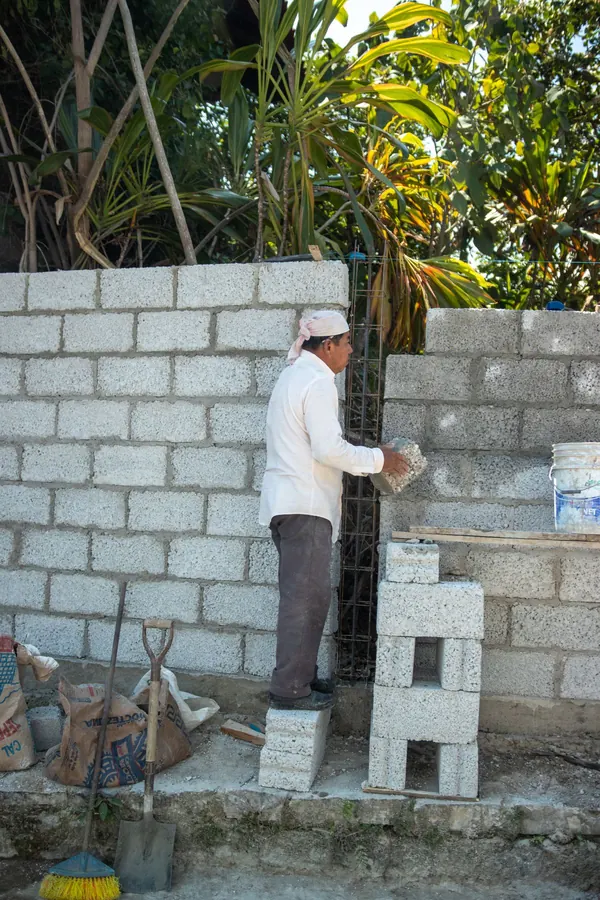 Concrete block wall going up course by course