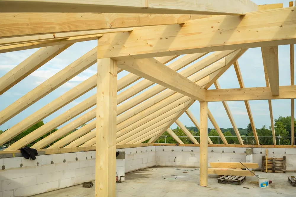 Timber roof trusses set over concrete block walls